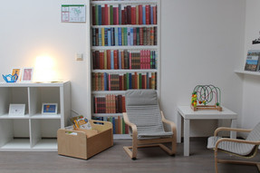 Eine Lese-Ecke im Flurbereich. Es befinden sich hier Sitzmöglichkeiten für Kinder und eine Auswahl an Büchern. Der Flurbereich wird stetig den Interessen der Kinder angepasst.