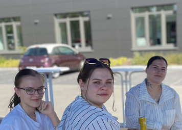 Drei Personen sitzen am Tisch
