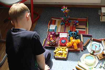 Kind spielt mit verschiedenen Baumaterialien